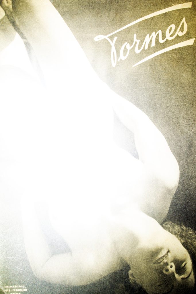 Archival pigment print of a reclining nude figure bathed in intense white overexposure against a dark sepia ground.