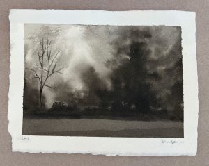 Ink wash landscape of a bare tree silhouetted against stormy dark clouds with a pale light column in the sky.
