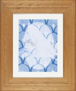 Two white egrets in flight drawn in chalk and graphite over a blue cyanotype background with a repeating fan pattern.