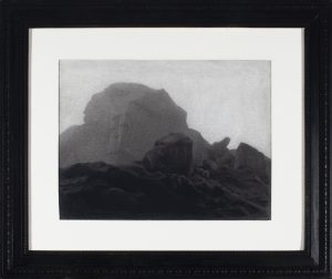 Charcoal drawing of a large rounded rock formation looming above dark boulders and rough ground beneath a pale sky.