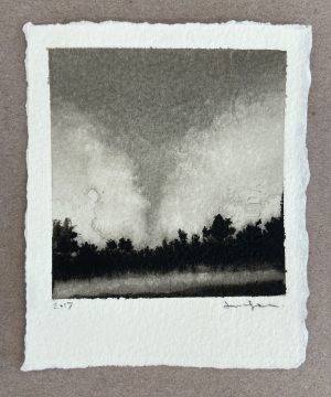 Ink landscape of a dark silhouetted treeline beneath a billowing storm cloud on rag paper.